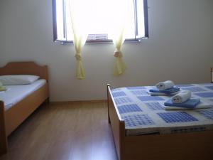 a bedroom with two beds with towels on them at Villa Welcome in Vrboska