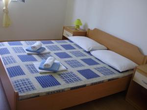 a bedroom with a bed with blue tiles on it at Villa Welcome in Vrboska