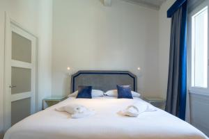 a bedroom with a bed with two towels on it at Carapelli Apartments in Florence