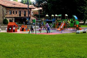 a park with a bunch of kids playing in it at Hotel Los Angeles in Santillana del Mar