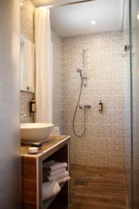 a bathroom with a sink and a shower at Hôtel Méditerranée in Calvi