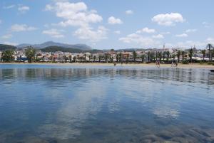 a large body of water with people on the beach at Myron Suite Old Town in Rethymno