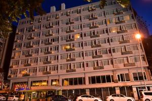 a building with cars parked in front of it at Gurkent Hotel in Ankara