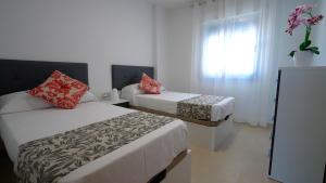 pokój hotelowy z dwoma łóżkami i oknem w obiekcie As Apartamentos Turisticos w mieście Morche