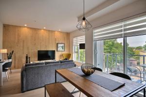 a living room with a couch and a table at The Modern Cocoon in Quebec City