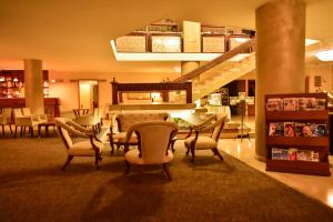 a lobby with a table and chairs and a staircase at Gurkent Hotel in Ankara