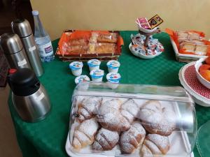 a table with a bunch of donuts on it at Villa Etna Sea in Piedimonte Etneo