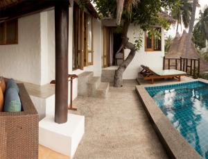 a villa with a swimming pool next to a house at Anankhira Villas in Koh Tao