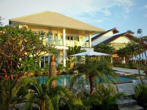 a house with a swimming pool and a resort at Mayo Resort in Umeanyar