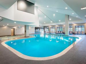 a large pool with blue water in a building at Ilgaz Mountain Resort Hotel in Ilgaz