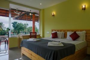 a bedroom with a bed with two towels on it at The Lake Paradise Boutique Resort in Alleppey +152 photos