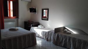 Postel nebo postele na pokoji v ubytování Hotel Borgo Antico