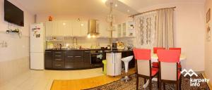 a kitchen with red chairs and a white refrigerator at Felice Riposo in Kozevo