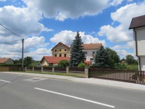 a street with houses and a fence on the side of the road at Mill House Apartment and Camping in Ljutomer