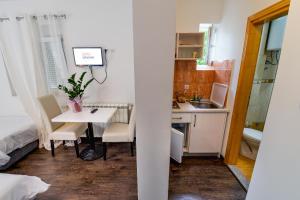 a small kitchen with a table and a sink in a room at Villa Marija in Trebinje