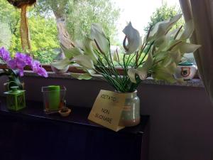 a vase of flowers sitting on a shelf in a window at Hotel Borgo Antico in San Severino