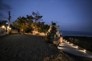 a house with lights on the side of a road at Skouros Villa in Kastrí