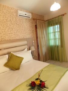 a bedroom with a bed with flowers on it at Studios Kentia in Skala Marion