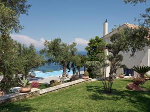 a villa with a garden and a swimming pool at Golden July Luxury Villa in Akrotiri