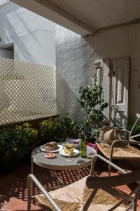 a patio with a table and chairs on a patio at Romantic - Casa Rua Bela in Porto