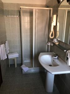 a bathroom with a sink and a shower at Hotel Frejus in Collegno