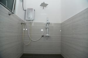 a shower with a shower head in a bathroom at Omee Guest in Mirissa +34 photos