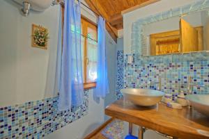 a bathroom with two sinks and a mirror at Villa Margherita by PosarelliVillas in Piegaio +20 photos