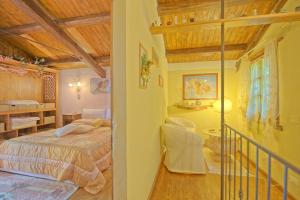 a bedroom with a bed and a staircase in a room at Villa Margherita by PosarelliVillas in Piegaio