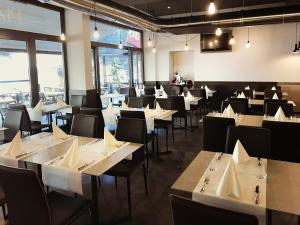 a dining room with white tables and chairs at Hotel Internazionale Bellinzona in Bellinzona