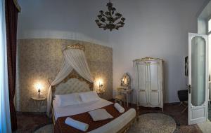 a bedroom with a bed and a chandelier at Palermo Gallery in Palermo