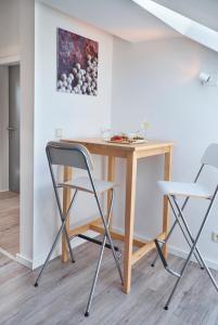 a table and two chairs in a room at Ferienwohnung Schwarz in Mayen +3 photos