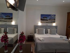 Postel nebo postele na pokoji v ubytování Angelica Hotel