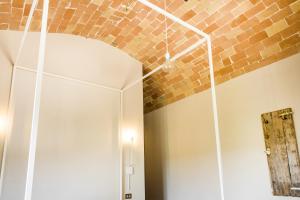 a room with a brick wall and a white door at Baldovino b&b in Villamagna
