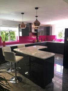 a kitchen with a large island with a counter top at Hadrian House in East Preston