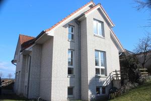 a white brick house with a red roof at Haus Feldmann in Ranzow