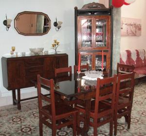 a dining room with a table and chairs and a mirror at Casa Colonial La Terraza in Havana