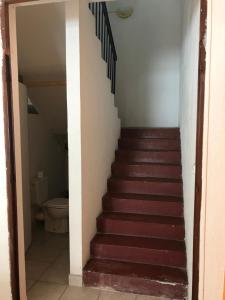 a staircase leading up to a room with a toilet at L'Escale du Mouillage in Saint-Pierre