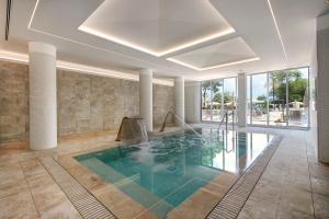 a swimming pool in a house with a ceiling at Hipotels Bahia Cala Millor - Adults Only in Cala Millor