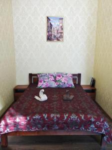 a bedroom with a bed with two swans on it at Gorsad Apartment in Odesa