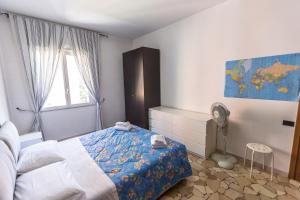 a bedroom with a bed and a window and a fan at Linate Airport Apartment in Milan