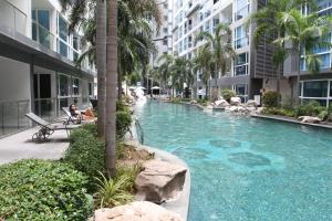 a swimming pool in the middle of a building at Central Pattaya Apartments in Pattaya