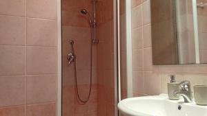 a bathroom with a shower with a sink and a shower head at B&B 55 Alghero in Alghero +23 photos