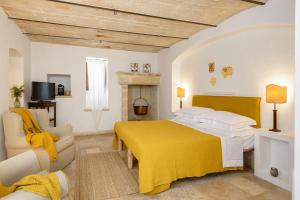 Säng eller sängar i ett rum på Masseria Marzalossa