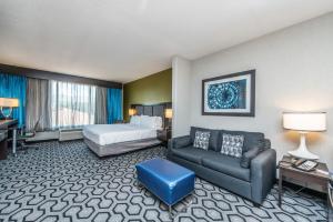 a hotel room with a bed and a couch at Holiday Inn Express and Suites North Charleston, an IHG Hotel in Charleston