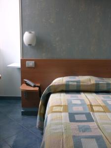 a bedroom with a bed and a table with a lamp at MeFra Camere - Amalfi Coast in Atrani