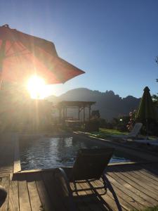 a chair sitting on a deck next to a pool at Domaine U Bugnu in Vico