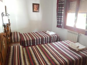 Postel nebo postele na pokoji v ubytování Apartamentos Turísticos Rural Los Tinaos