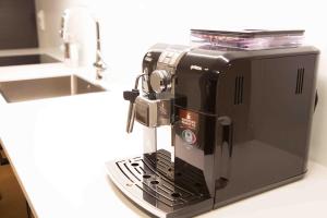 a black coffee maker sitting on a kitchen counter at Executive Living Östermalm Suite in Stockholm