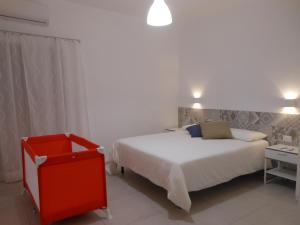 a bedroom with a white bed and a red cabinet at La rosa dei venti in Gaeta