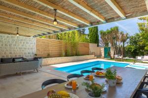 a patio with a table and a swimming pool at Villa Hedera II in Dubrovnik